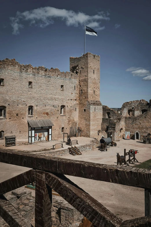 a building built in rocks and has a flag on it