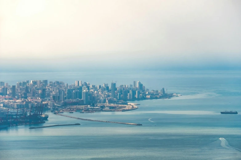 city with ocean and boats below in daytime