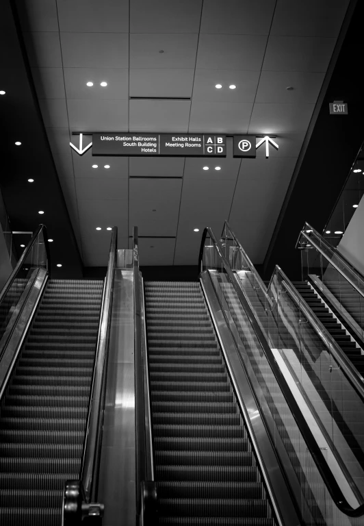 two escalators in an airport or shopping mall