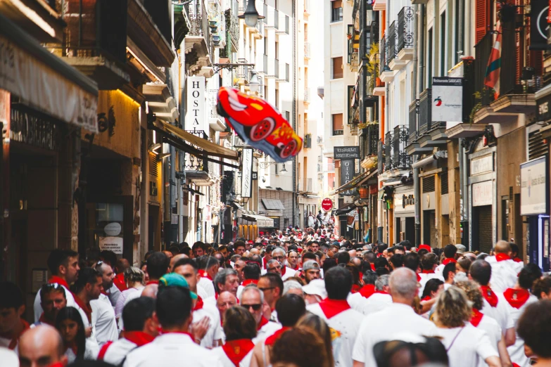 a group of people walking down a crowded street