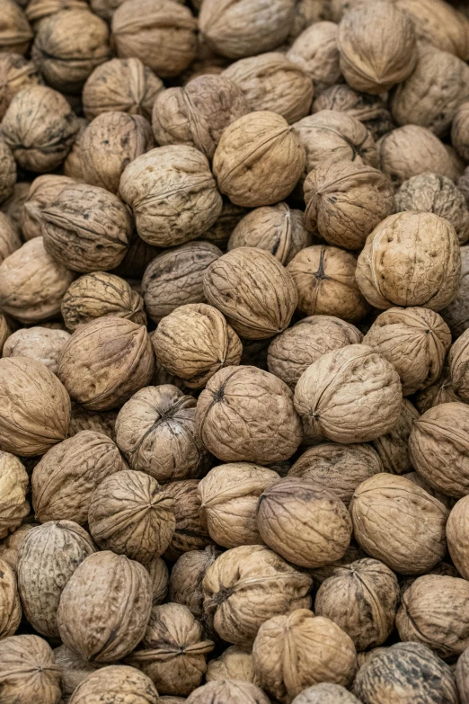 a pile of walnuts sitting on top of a wooden table