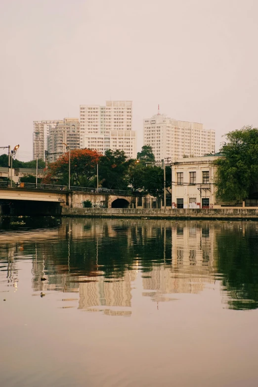 some buildings sitting over the water and a bridge