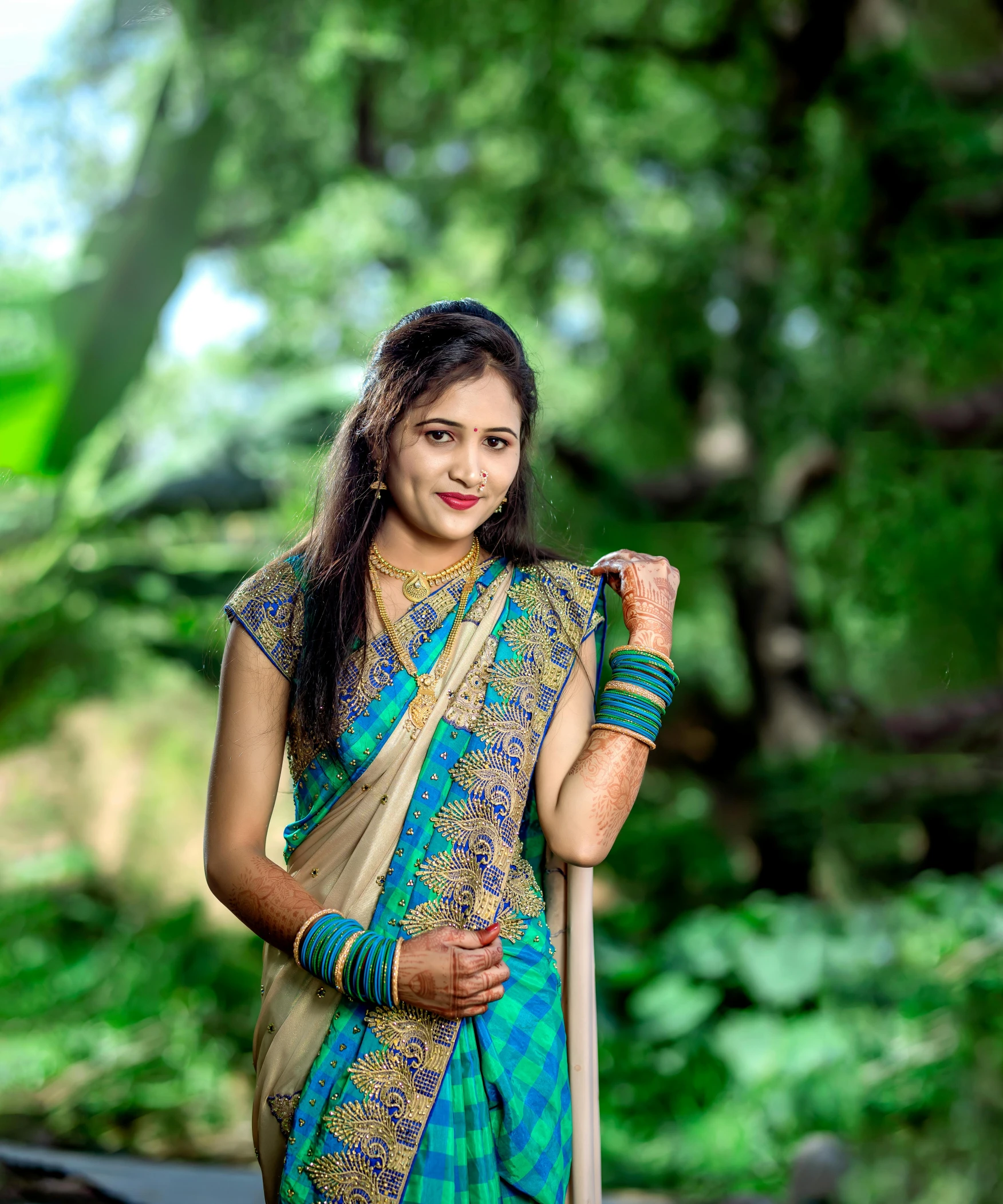 a beautiful young woman in a blue and gold sari