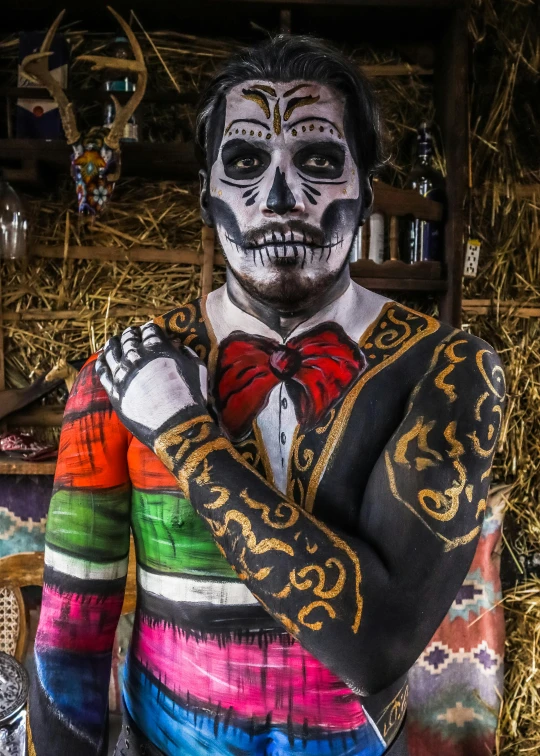 a man with white makeup and brightly colored clothing