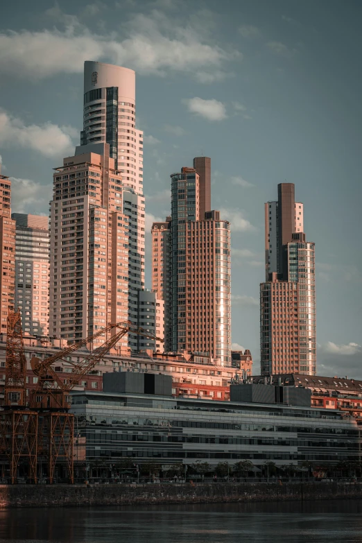 a boat sailing through the water in front of high rise buildings