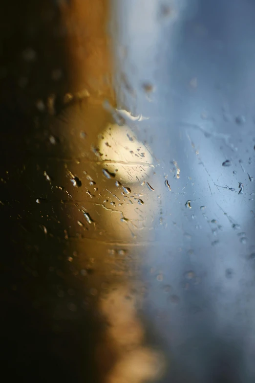 drops of water on a windshield reflecting the light