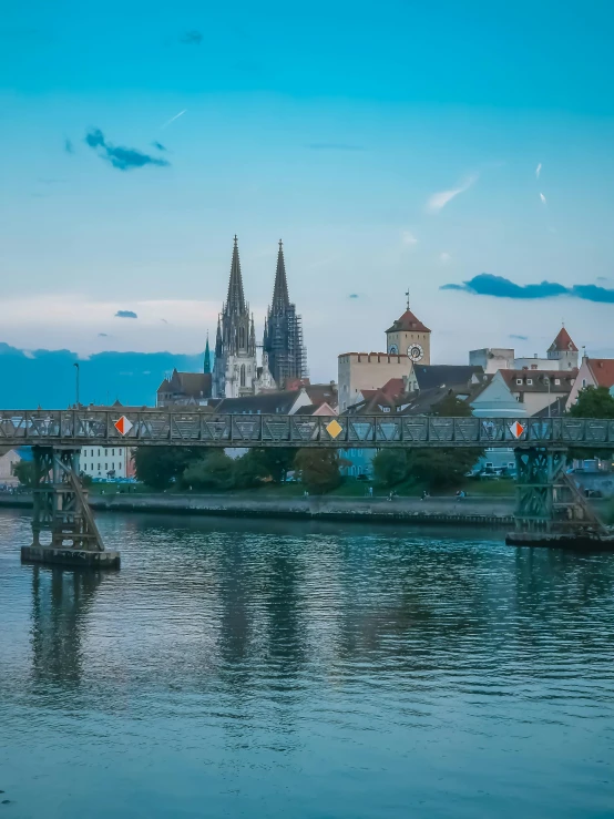 the town is reflected in the water of a river