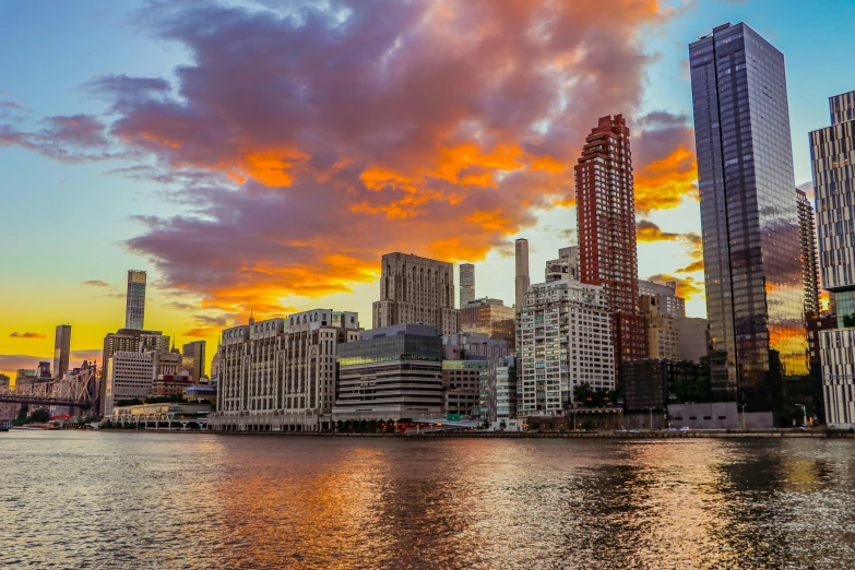 city buildings are shown with the sunset in the background