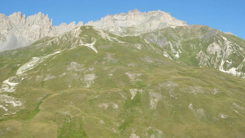 green mountains against a blue sky with clouds