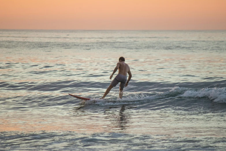 a man riding the waves on top of a surfboard