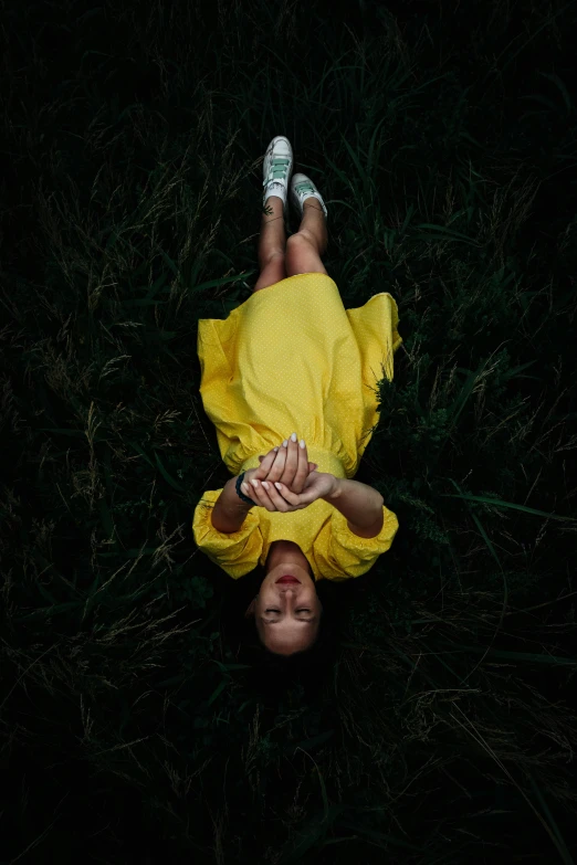 a person laying in the grass in the sun