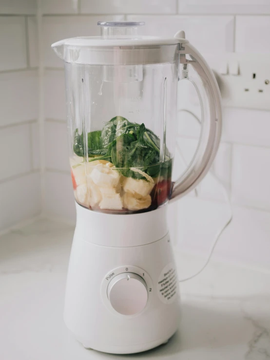 a blender full of vegetables on a counter