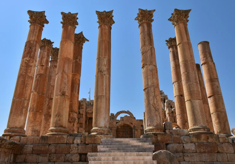 several large ancient pillars are stacked against the sky