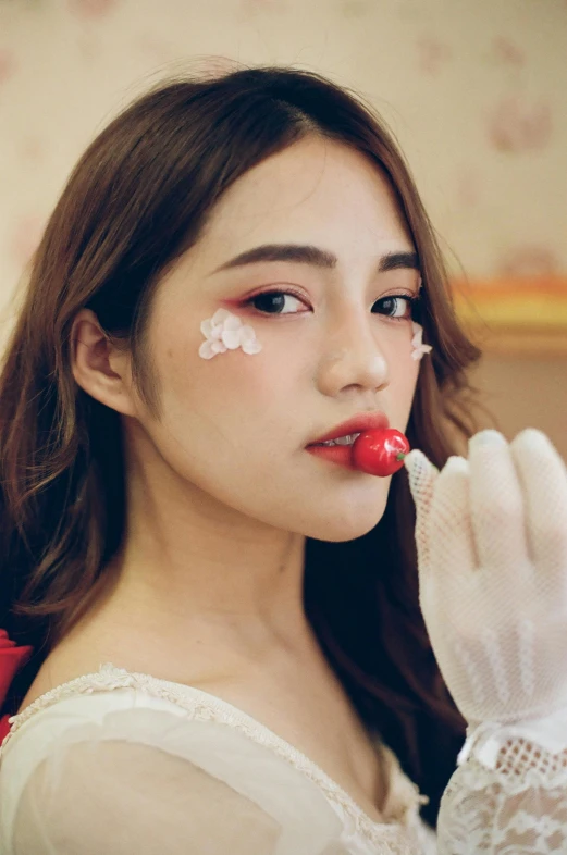 a asian woman with flowers painted on her face and nails