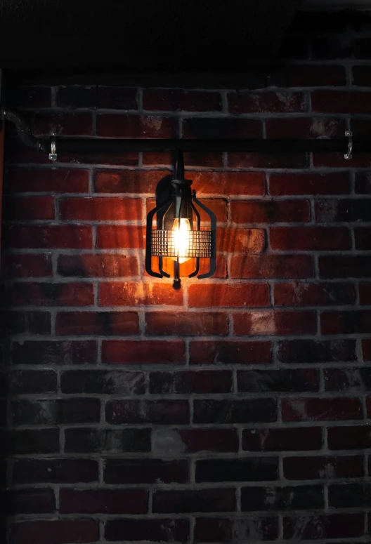 a brick wall with a lantern hanging from it