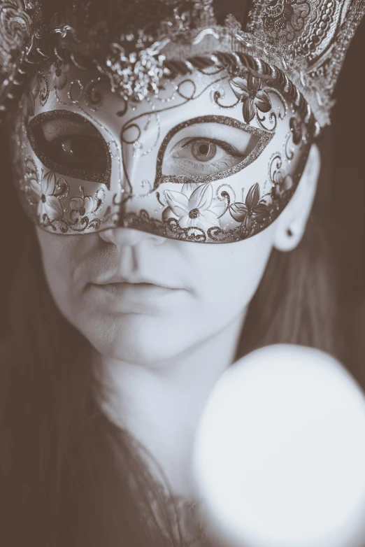 a beautiful young lady wearing a carnival mask