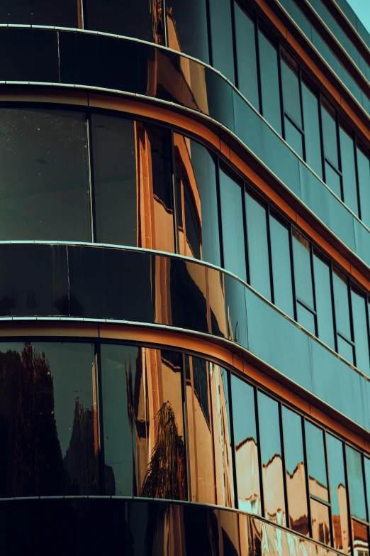 a tall brown building reflecting its light outside