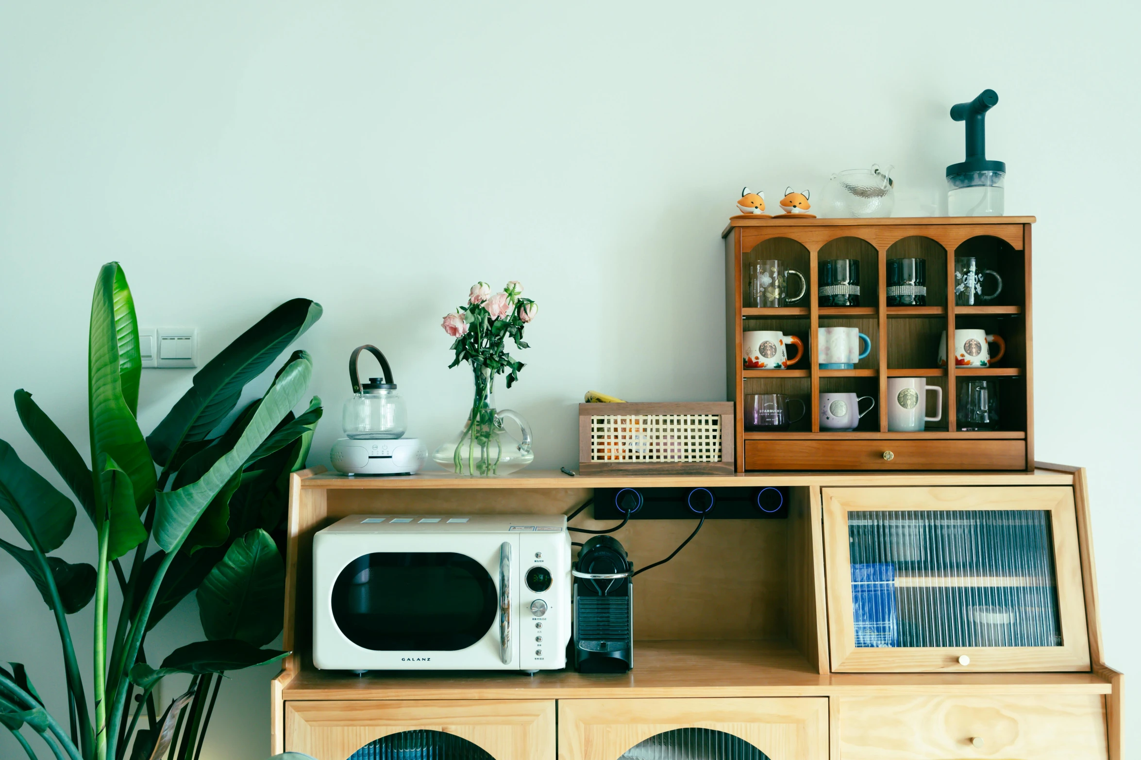 a table with a microwave and a plant on it