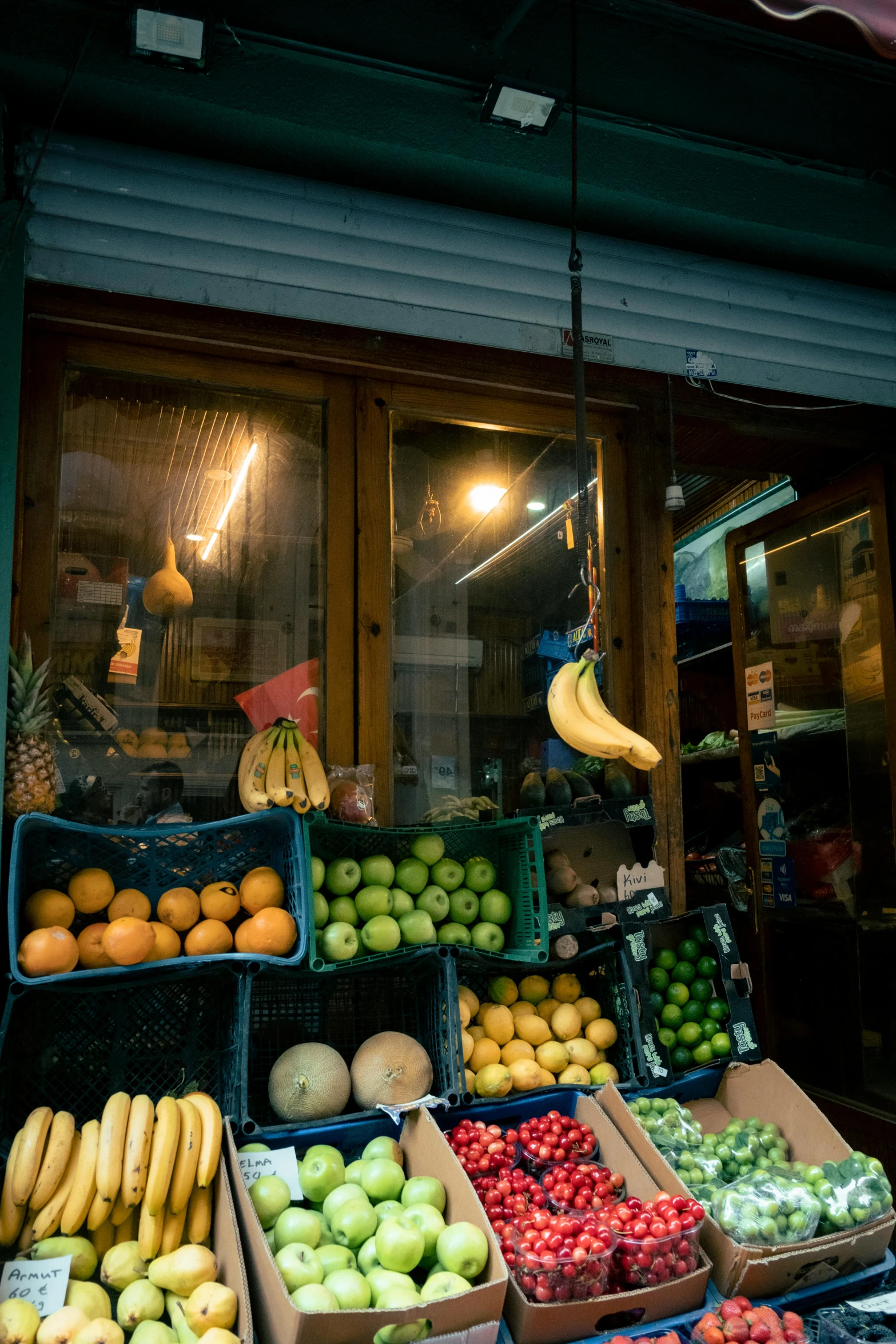 an open window shows a fruit stand with fresh fruits in it