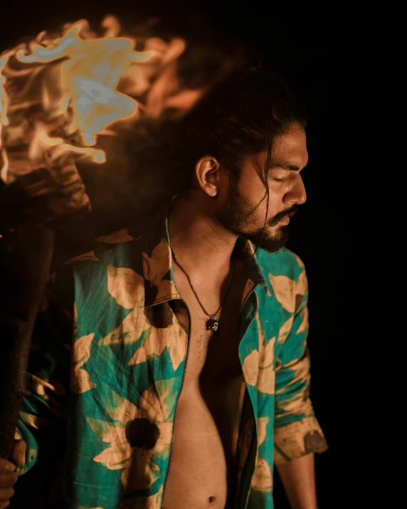 a man in floral shirt with hair blowing in the wind