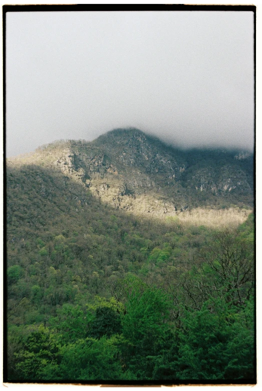 the mountains are covered in mist as seen from the ground