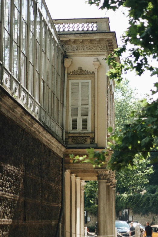 a building with columns that are near a tree