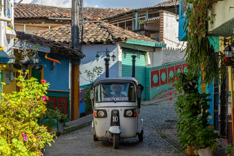 an old car in the middle of a city street