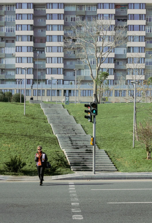 a person walking up the side walk and down to a street