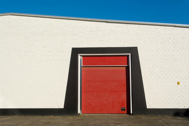 an image of a red door and white brick wall