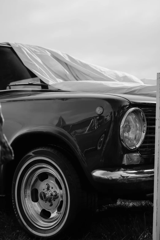 old classic car parked in grass in a black and white po