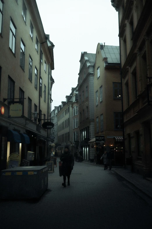 a couple of people that are walking down a street