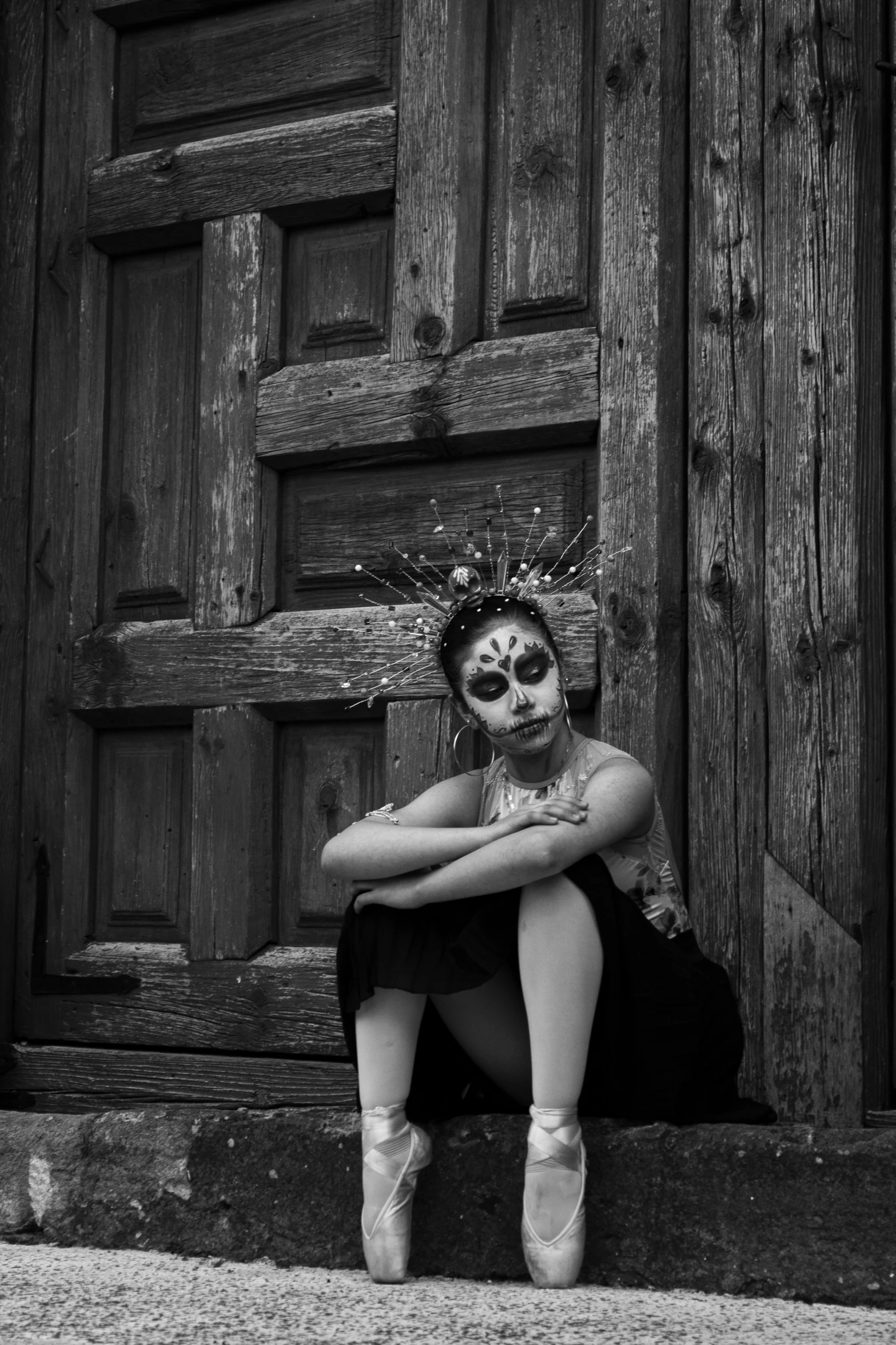 a person sitting on steps with their head painted white