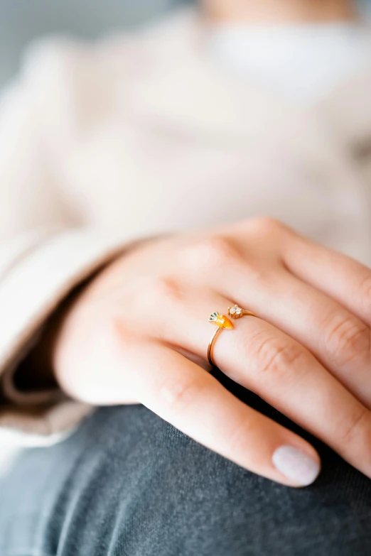 a woman is holding her engagement ring