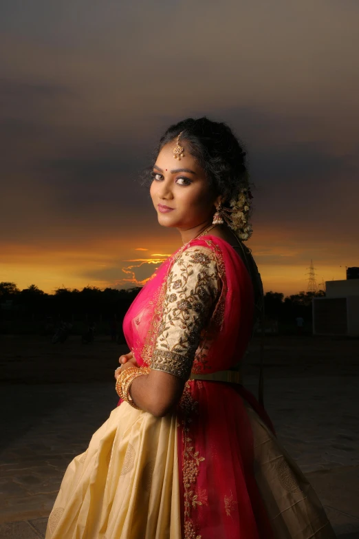 a woman wearing a sari and posing for a pograph