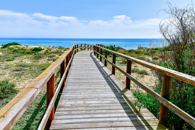 a long wooden path in the sand