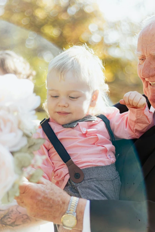 an older gentleman is showing a  what she likes to eat