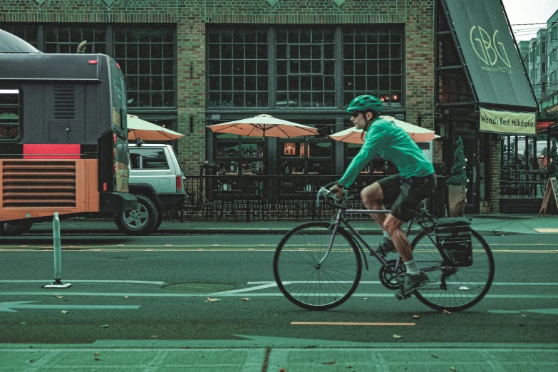 man riding his bike down the street during the day