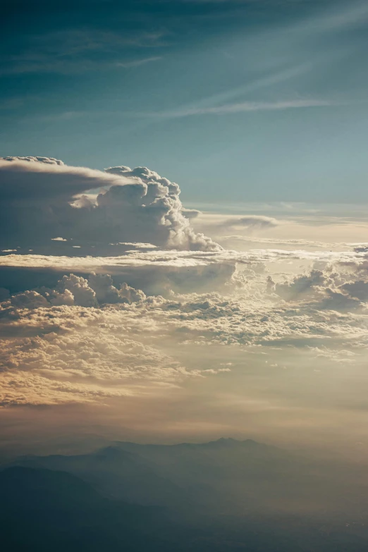 clouds and hills with the sun going down in the sky