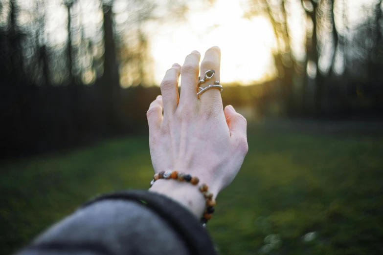 a woman holds up her hand with her ring