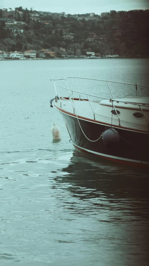 a boat is sitting in the ocean and is being washed up