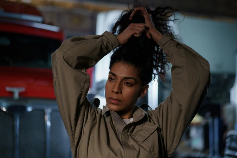 a woman wearing a shirt and holding her hair up to her head