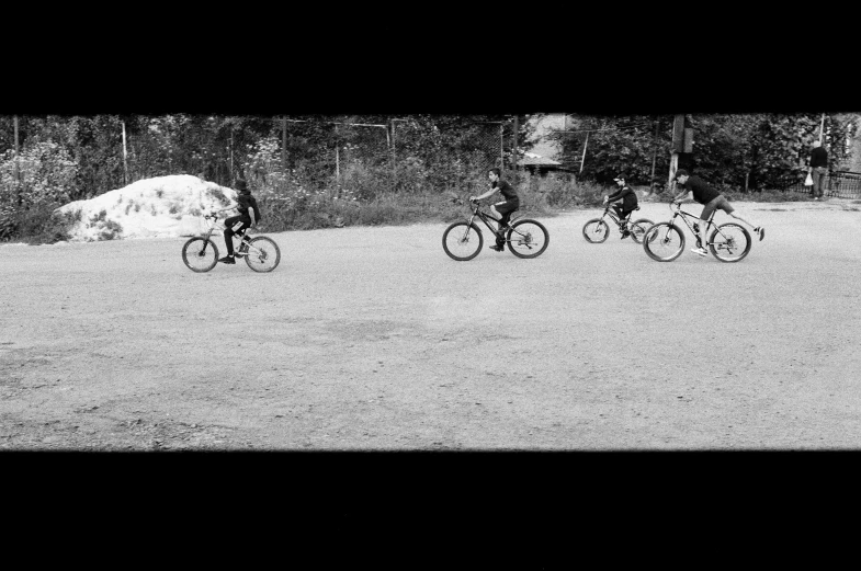 people riding bicycles and a bull in the middle