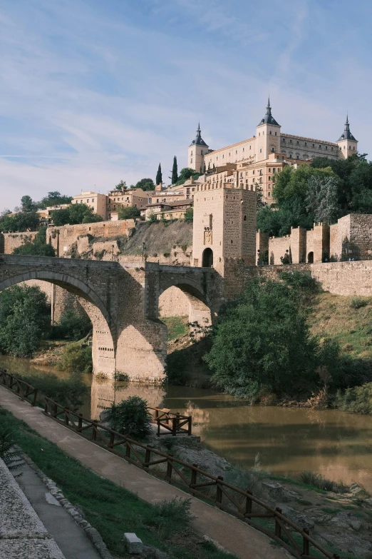 a bridge crosses over a river with buildings on top