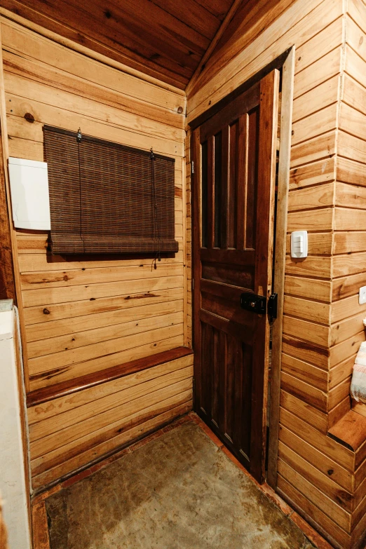 a bathroom with wooden floors and walls