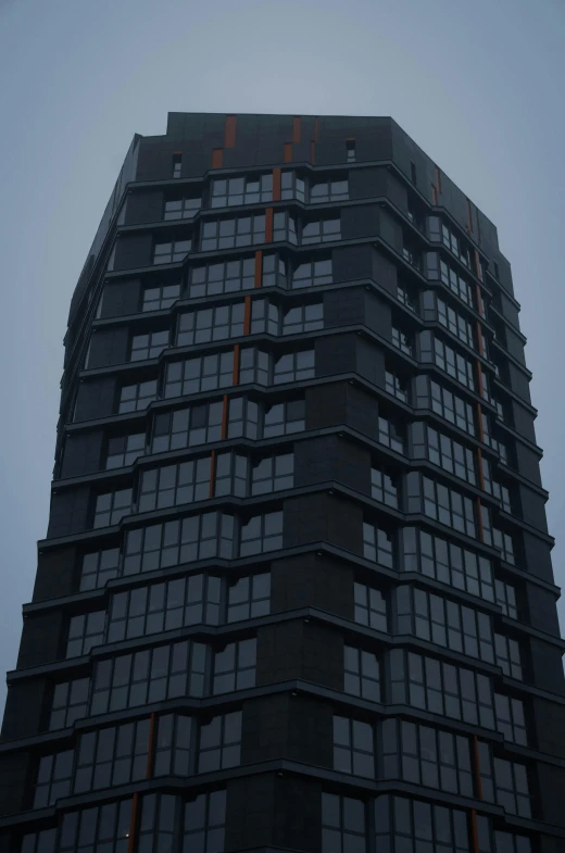 the top of a tall building with windows and a clock in the front