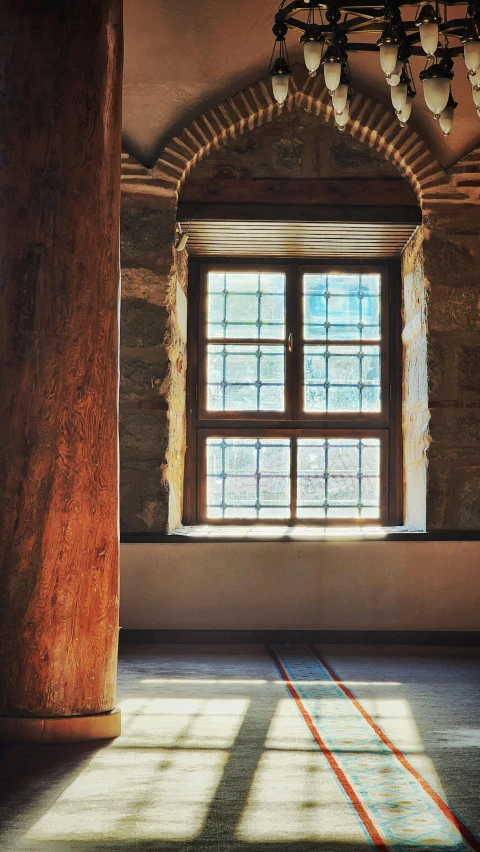 a window sits in a corner of the room