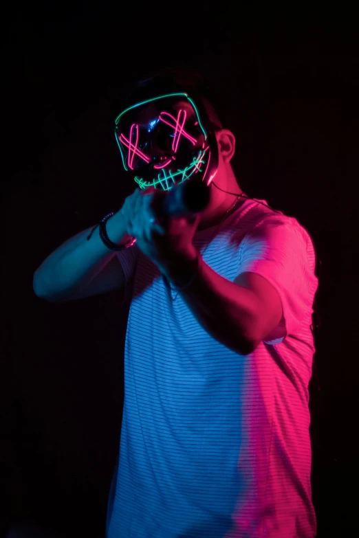 a man in a neon mask is holding his hand on his hip