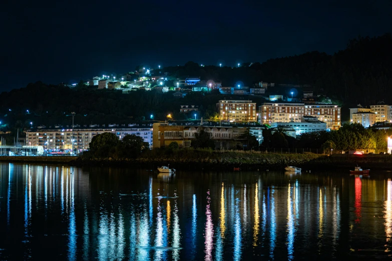 the view from the water of city lights in the distance