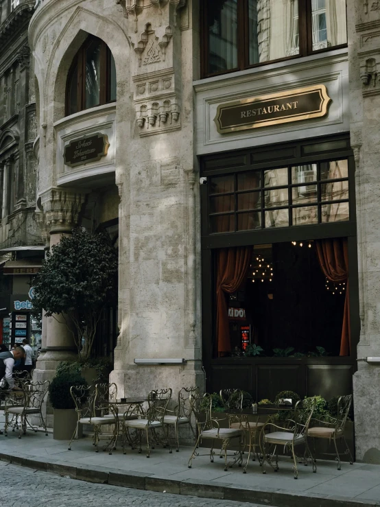 a cobbled street with tables and chairs, and an ornate building