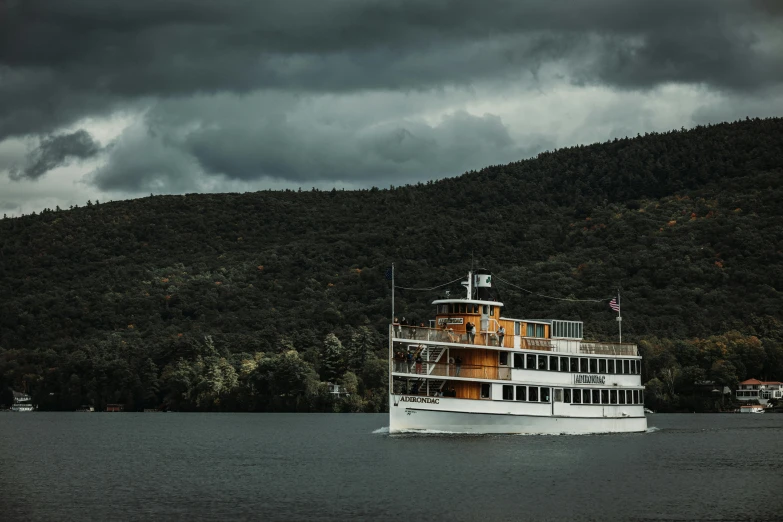 a big boat on the water surrounded by land